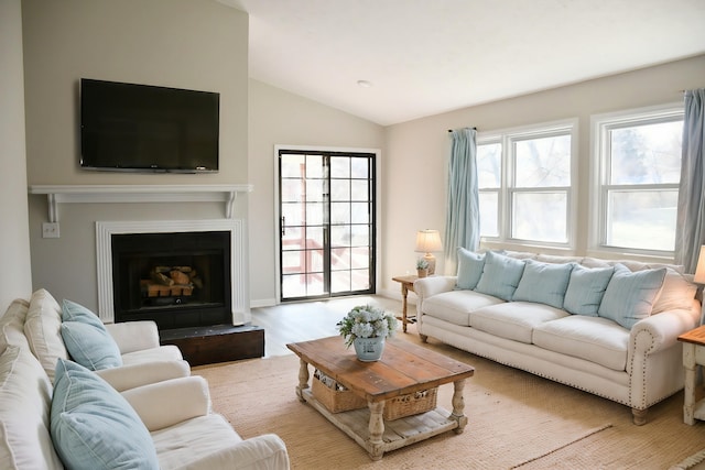 living room featuring vaulted ceiling and light hardwood / wood-style floors