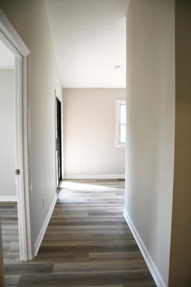 corridor with dark wood-type flooring