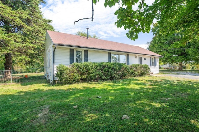 ranch-style home with a front lawn