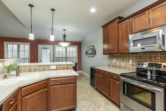 kitchen featuring wine cooler, stainless steel appliances, a sink, decorative backsplash, and pendant lighting