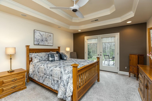 bedroom with light carpet, visible vents, a raised ceiling, access to exterior, and french doors