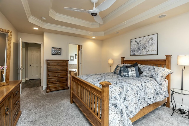 carpeted bedroom with a tray ceiling, recessed lighting, a ceiling fan, and crown molding