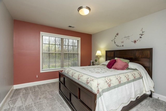 bedroom featuring light colored carpet, visible vents, and baseboards