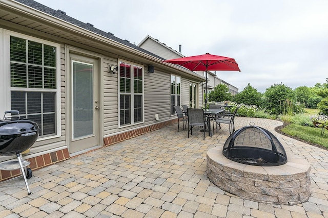 view of patio / terrace with a grill, a fire pit, and outdoor dining space