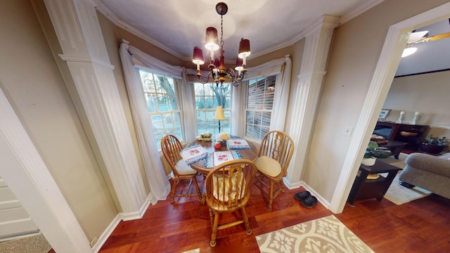 dining area with crown molding, dark hardwood / wood-style floors, and a chandelier