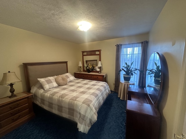 bedroom featuring carpet floors and a textured ceiling