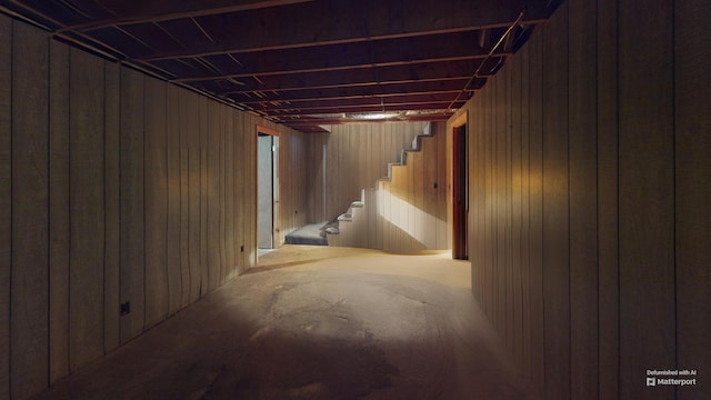 basement featuring wooden walls