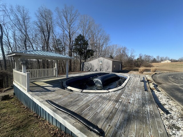 back of house with a wooden deck, a pergola, and a lawn