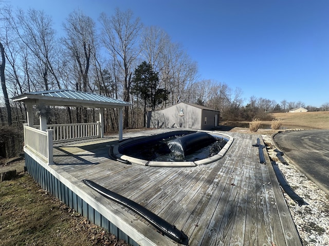 view of pool featuring a gazebo and a wooden deck