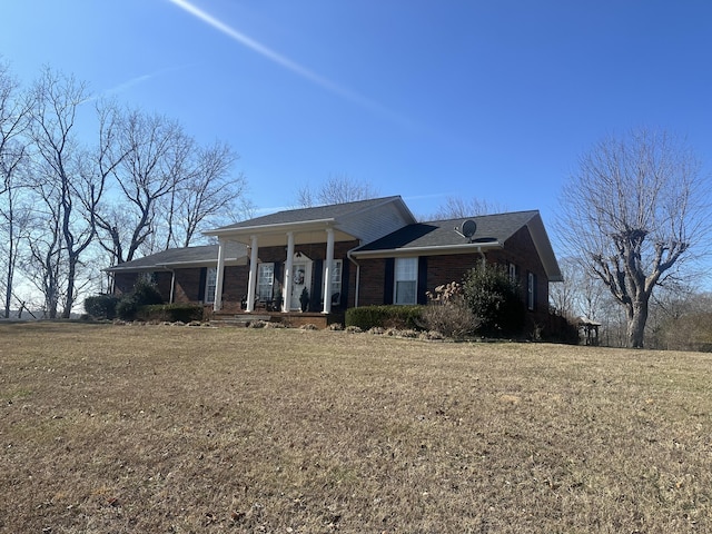 single story home featuring a front lawn and a porch