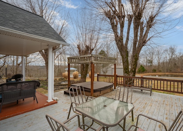 wooden deck with outdoor dining area and a covered hot tub