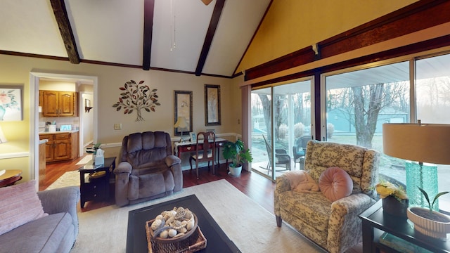 living room with light hardwood / wood-style flooring and vaulted ceiling with beams