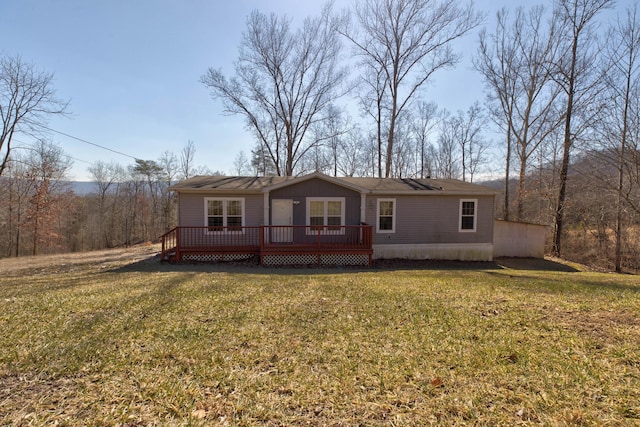 view of front of house featuring a front lawn and a deck