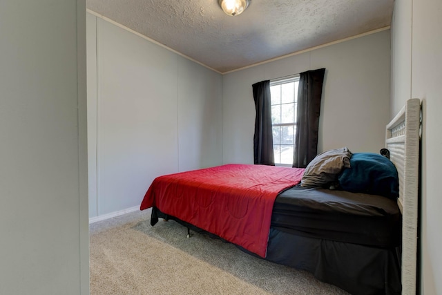 bedroom with carpet floors, ornamental molding, and a textured ceiling