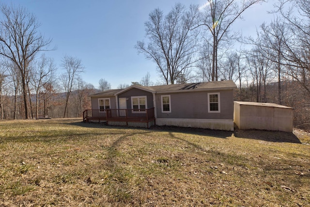 exterior space featuring a wooden deck and a front lawn