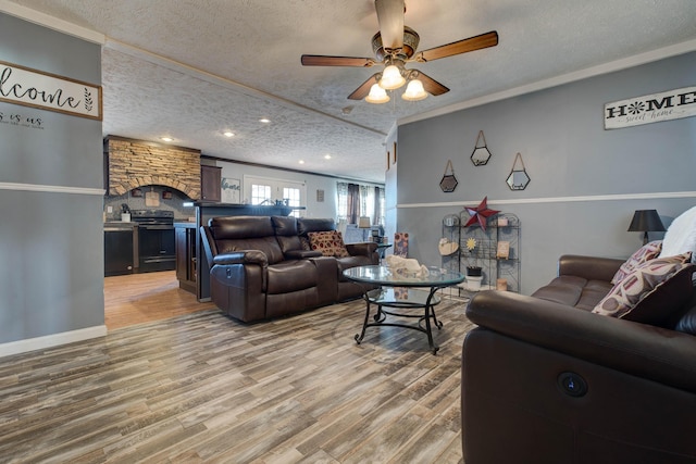 living room featuring crown molding, hardwood / wood-style floors, ceiling fan, and a textured ceiling