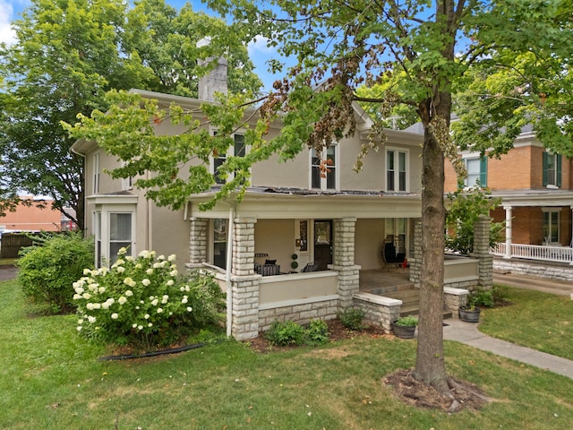 view of front facade with a front lawn and a porch