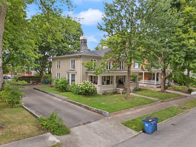 view of front of house with a porch and a front lawn