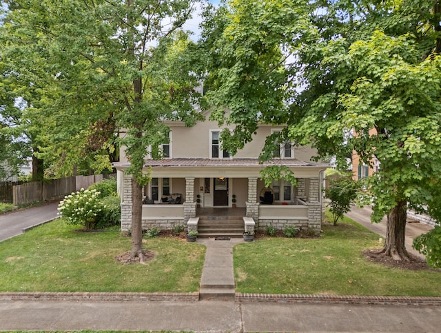 view of front of home with covered porch and a front yard