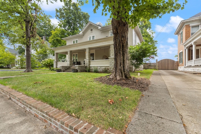 view of front of property featuring covered porch and a front yard