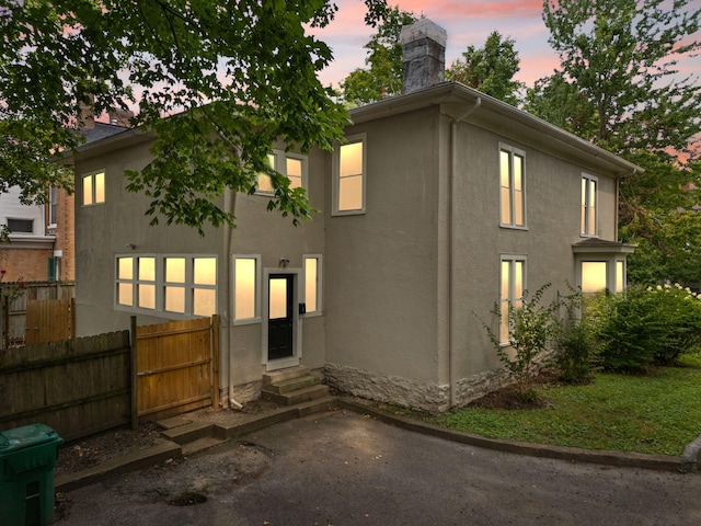 view of back house at dusk