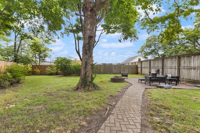 view of yard with a patio and an outdoor fire pit