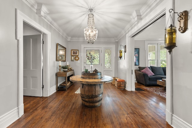 hall featuring crown molding, a notable chandelier, and dark hardwood / wood-style flooring