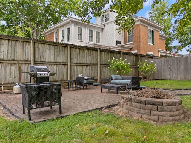 view of patio / terrace with grilling area and a fire pit