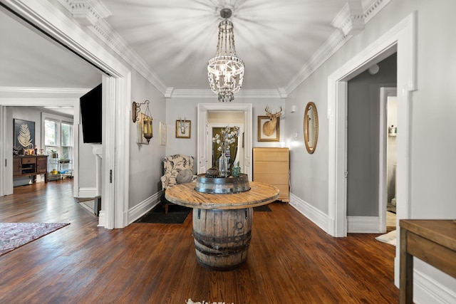 hallway with dark wood-type flooring, ornamental molding, and a notable chandelier