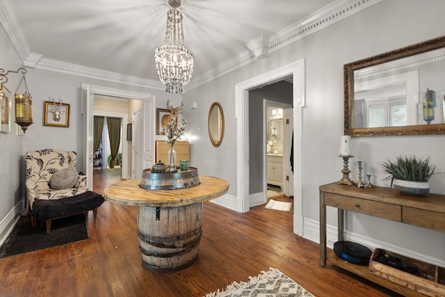 sitting room with an inviting chandelier, ornamental molding, and dark hardwood / wood-style floors