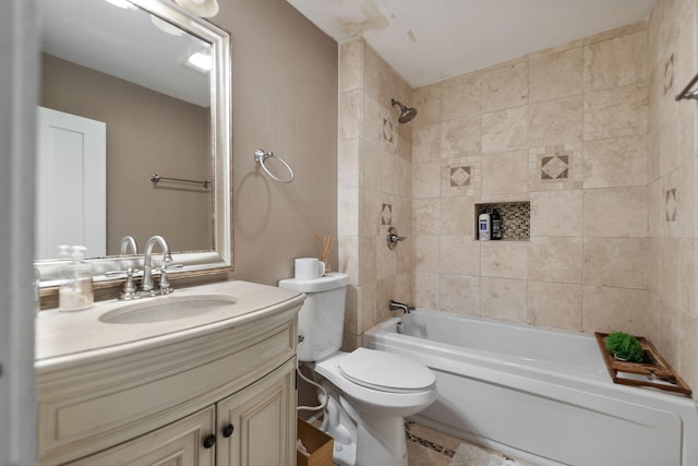 full bathroom with vanity, tiled shower / bath combo, and toilet