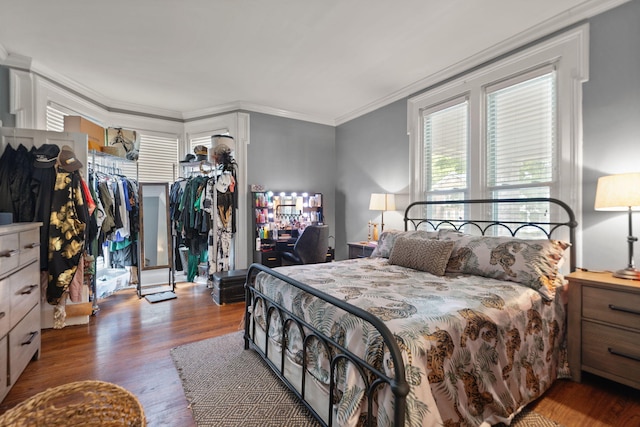 bedroom with crown molding and hardwood / wood-style floors