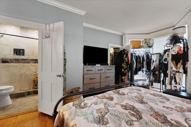 bedroom featuring connected bathroom, ornamental molding, and light hardwood / wood-style floors