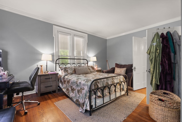 bedroom featuring hardwood / wood-style floors and crown molding