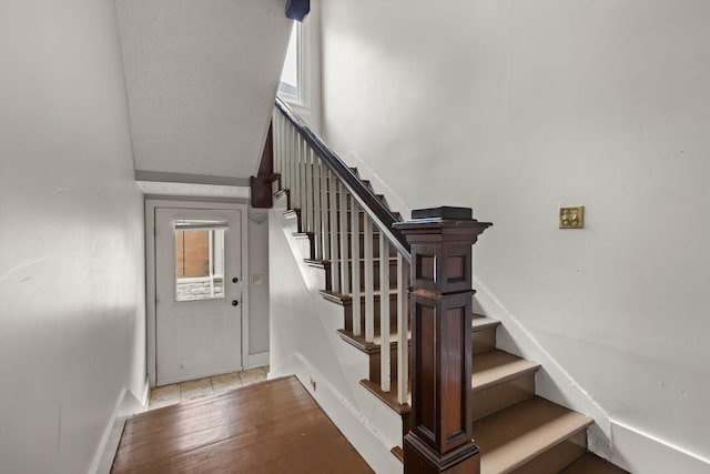 stairway featuring wood-type flooring