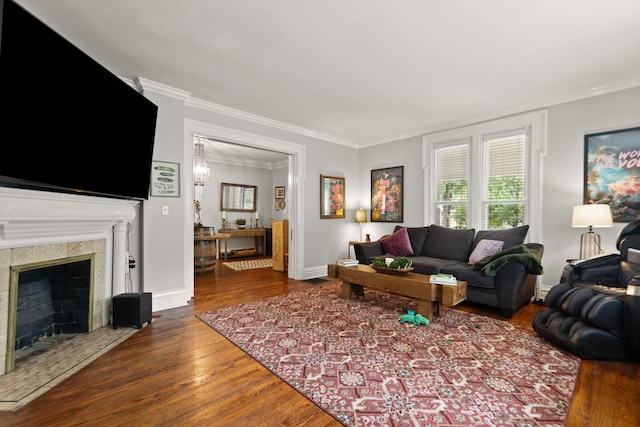 living room featuring hardwood / wood-style flooring, a fireplace, and ornamental molding