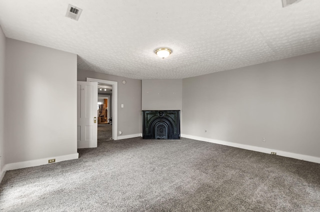 unfurnished living room featuring carpet and a textured ceiling