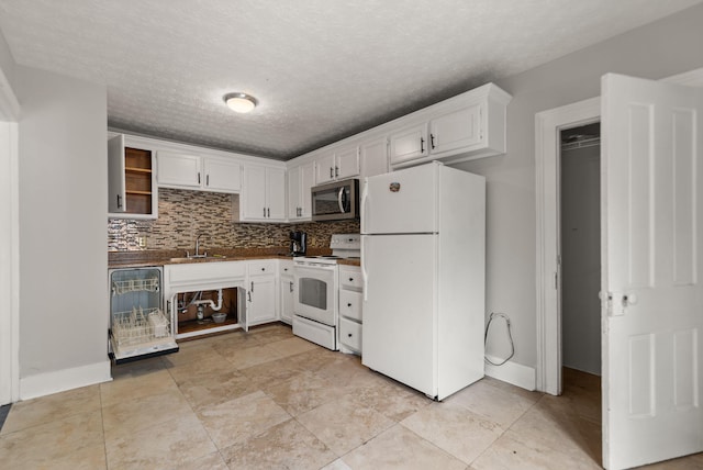 kitchen featuring white cabinetry, sink, white appliances, and decorative backsplash