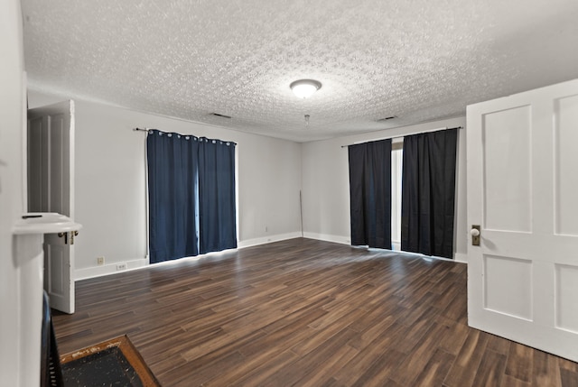 interior space with dark hardwood / wood-style flooring and a textured ceiling