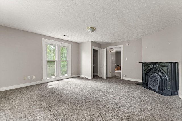 unfurnished living room featuring carpet floors and a textured ceiling