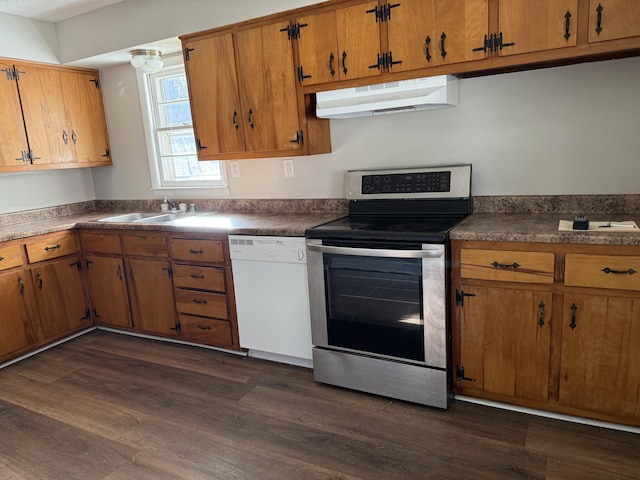 kitchen featuring sink, dark wood-type flooring, white dishwasher, and stainless steel range with electric stovetop