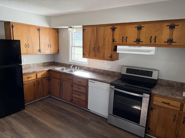 kitchen featuring stainless steel electric range oven, dark hardwood / wood-style floors, black refrigerator, sink, and white dishwasher