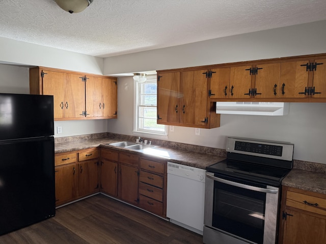 kitchen featuring dark wood-type flooring, sink, stainless steel range with electric cooktop, black fridge, and white dishwasher