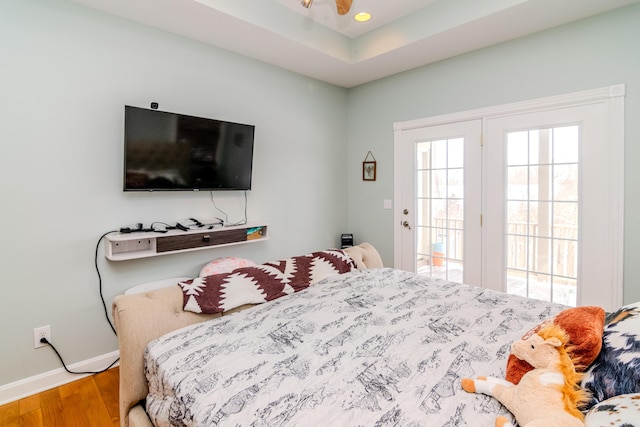 bedroom with baseboards, wood finished floors, and recessed lighting