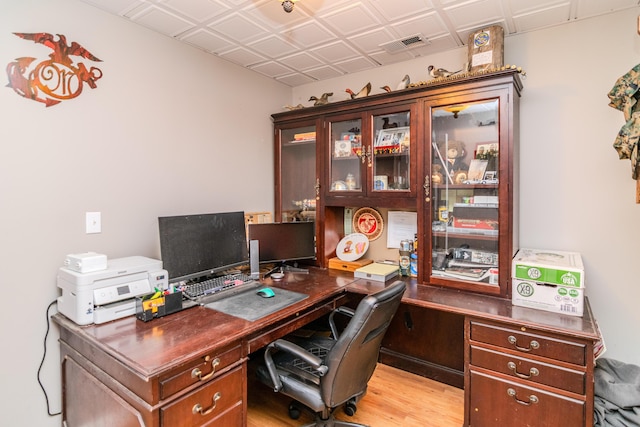 home office with an ornate ceiling, visible vents, and light wood finished floors