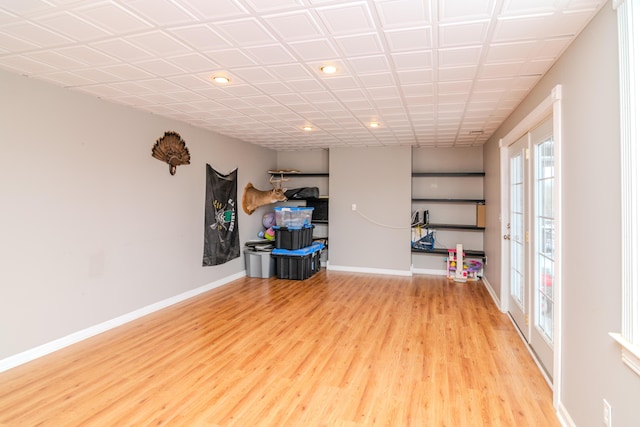 interior space with baseboards and wood finished floors