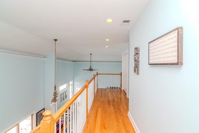 hall featuring baseboards, visible vents, an upstairs landing, light wood-type flooring, and recessed lighting