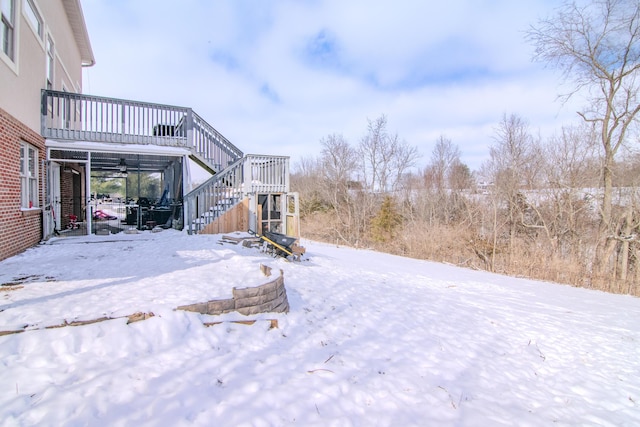 yard covered in snow featuring stairs