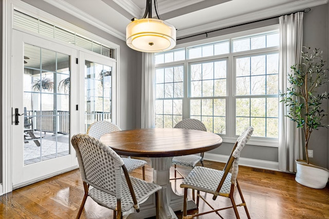 dining space featuring crown molding and hardwood / wood-style flooring