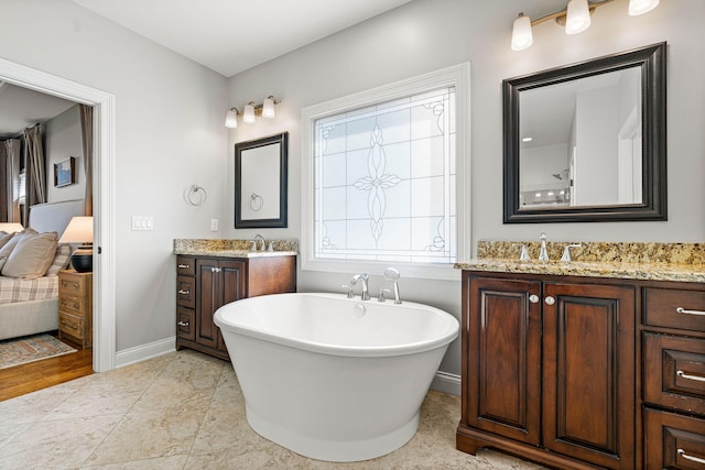 bathroom with vanity and a tub to relax in